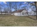 Spacious backyard with lawn featuring a home with white siding and a brown roof, perfect for outdoor activities at 3104 Alice Ave, Indianapolis, IN 46237