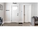 Bright entryway featuring wood floors, white doors, and modern decor at 3732 N Kenwood Ave, Indianapolis, IN 46208
