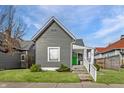 Inviting gray home showcasing a well-kept lawn and a bright green front door at 3732 N Kenwood Ave, Indianapolis, IN 46208
