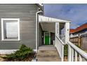 Close-up of the front porch with a bright green door and white railings at 3732 N Kenwood Ave, Indianapolis, IN 46208