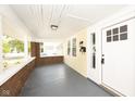 Inviting covered porch with brick accents, classic lighting, and clear view of the home's address at 415 Ruskin Pl, Indianapolis, IN 46205