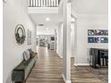 Inviting entryway boasting wood floors, neutral walls, a stylish bench, and views of other rooms at 4179 Ironclad Dr, Bargersville, IN 46106