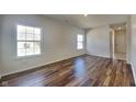 Bright living room with hardwood floors and multiple windows providing ample natural light at 5467 Powder River Ct, Indianapolis, IN 46221