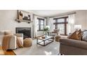 Bright living room with hardwood floors, a fireplace, and an abundance of natural light at 5534 Guilford Ave, Indianapolis, IN 46220