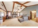 Spacious living room featuring high ceilings, wood beams, and a cozy fireplace at 7152 Sandalwood Dr, Avon, IN 46123
