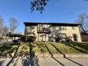 Exterior shot featuring a well-maintained lawn and convenient carport at 7902 Benjamin Dr, Lawrence, IN 46226