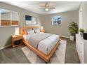 Cozy main bedroom features a neutral color palette, stylish furnishings and a large bed at 10225 Bayton Ct, Indianapolis, IN 46229