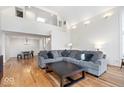 Cozy living room with a large grey sofa, hardwood floors, and abundant natural light at 10249 Southwind Dr, Indianapolis, IN 46256