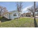 Exterior shot highlighting its light blue siding and proximity to surrounding greenery and neighborhood charm at 1039 S Ohio St, Martinsville, IN 46151