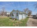 View of the exterior showing the house's side profile with a driveway at 1039 S Ohio St, Martinsville, IN 46151
