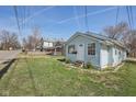 Light blue house on a sunny day, showcasing its compact design and inviting curb appeal at 1039 S Ohio St, Martinsville, IN 46151