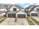 Charming townhouses with gray garages, stone accents, and white siding offer curb appeal at 10744 Eldorado Cir, Noblesville, IN 46060