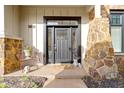 Inviting front entryway features stone accents and a welcoming dark door at 10744 Eldorado Cir, Noblesville, IN 46060