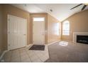 Spacious living room featuring tiled entryway, vaulted ceilings, a fireplace, and large, arched windows at 123 Bridgemor Ln, Mooresville, IN 46158