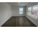 Bright bedroom features wood-look floors and is illuminated by natural light filtering through large windows at 1265 Fleming Dr, Greenfield, IN 46140