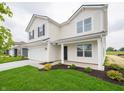 Two-story home with a well-manicured lawn, a two-car garage, and a cozy front porch at 1265 Fleming Dr, Greenfield, IN 46140