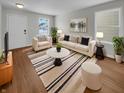 Bright living room featuring neutral walls, hardwood floors, a large sofa and lots of natural light at 15503 Sandlands Cir, Noblesville, IN 46060