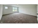 Cozy bedroom featuring plush carpeting and a large window offering great natural light at 1618 Trichel Dr, Greenwood, IN 46143