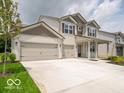 Charming two-story home featuring a spacious three-car garage and well-manicured front lawn at 1618 Trichel Dr, Greenwood, IN 46143