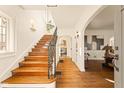 Bright foyer with hardwood floors, staircase, and elegant archways leading to living areas at 219 Blue Ridge Rd, Indianapolis, IN 46208