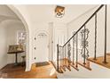 Inviting foyer with stained glass window and hardwood floors at 219 Blue Ridge Rd, Indianapolis, IN 46208