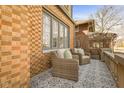 Relaxing patio with wicker chairs and patterned tile floor, perfect for outdoor lounging at 219 Blue Ridge Rd, Indianapolis, IN 46208