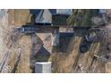 Aerial view of property showcasing the home, detached garage, and surrounding landscape at 2207 E Dudley Ave, Indianapolis, IN 46227