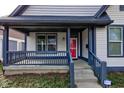 Welcoming front porch featuring a seating area and views of the landscaped yard at 2432 N Talbott St, Indianapolis, IN 46205