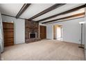 Spacious living room features a cozy fireplace with exposed brick and decorative ceiling beams at 3029 Oberlin Ct, Indianapolis, IN 46268