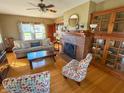 Inviting living room featuring hardwood floors, brick fireplace and beautiful built-in cabinets at 34 W Main St, Brownsburg, IN 46112
