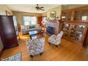 Inviting living room featuring hardwood floors, brick fireplace and beautiful built-in cabinets at 34 W Main St, Brownsburg, IN 46112