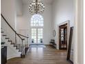 Grand foyer with high ceilings, chandelier, staircase, and wood floors at 3497 Sedgemoor Cir, Carmel, IN 46032