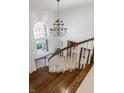 Elegant foyer with staircase, chandelier and view of the front entrance at 3497 Sedgemoor Cir, Carmel, IN 46032