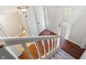 Bright foyer showcasing hardwood floors, a staircase, and a view of the front door at 3705 River Rd, Columbus, IN 47203