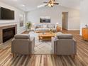 Inviting living room with vaulted ceilings, fireplace, modern furnishings, and light hardwood floors at 3936 Par Dr, Indianapolis, IN 46268