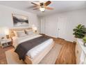 Comfortable main bedroom with soft lighting, a ceiling fan, and neutral decor at 3936 Par Dr, Indianapolis, IN 46268