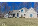 Brick home with mature landscaping featuring a sprawling lawn and mature trees at 3948 S Woodfield Dr, New Palestine, IN 46163