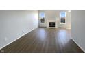 Inviting living room featuring a modern fireplace and beautiful hardwood flooring at 3951 Narrowleaf Ct, Indianapolis, IN 46235