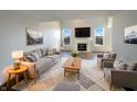 Bright living room with a fireplace, large windows, and stylish furniture and decor at 3951 Narrowleaf Ct, Indianapolis, IN 46235