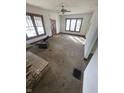 Empty living room featuring a fireplace and windows providing natural light, needs repairs at 408 E Monroe St, Alexandria, IN 46001