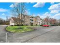 Side angle view of apartment building with parking, a fire hydrant, and manicured green space at 4925 Opal Ridge Ln # 309, Indianapolis, IN 46237