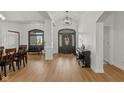 Bright foyer features high ceilings, wood-look floors, and a decorative glass front door at 5529 W Mccord Rd, McCordsville, IN 46055