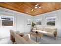 Bright living room featuring a unique wood plank ceiling, neutral furniture, and an abundance of natural light at 5884 Kingsley Dr, Indianapolis, IN 46220