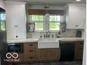 Bright, modern kitchen featuring a farmhouse sink, custom cabinetry, and high-end finishes at 5951 W St Rd 32 W, Anderson, IN 46011