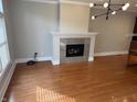 A cozy fireplace is the centerpiece of this living room with hardwood floors at 614 E 11Th St, Indianapolis, IN 46202