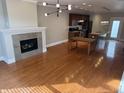 Open concept living space featuring hardwood floors, a stone fireplace, and modern lighting fixtures at 614 E 11Th St, Indianapolis, IN 46202