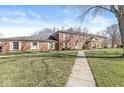 Brick two story building with well-maintained lawn at 7434 King George Dr # A, Indianapolis, IN 46260