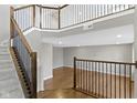Open entryway boasts hardwood floors, a staircase with dark wood and light gray accents at 903 E 16Th St, Indianapolis, IN 46202