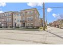 Charming brick townhome with professional landscaping, a fenced yard, and inviting curb appeal at 903 E 16Th St, Indianapolis, IN 46202
