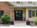 Inviting entrance with double doors, stone walkway, and decorative planters enhancing curb appeal at 9080 Pickwick Dr, Indianapolis, IN 46260